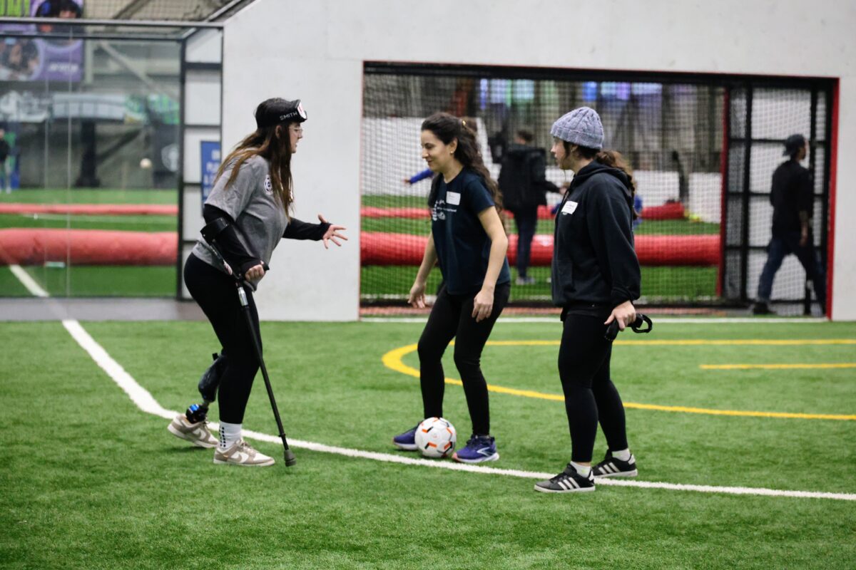 UASA participants of all disabilities take part in a blind soccer clinic, practicing kicking the ball while wearing USABA eyeshades and following the advice of the guides