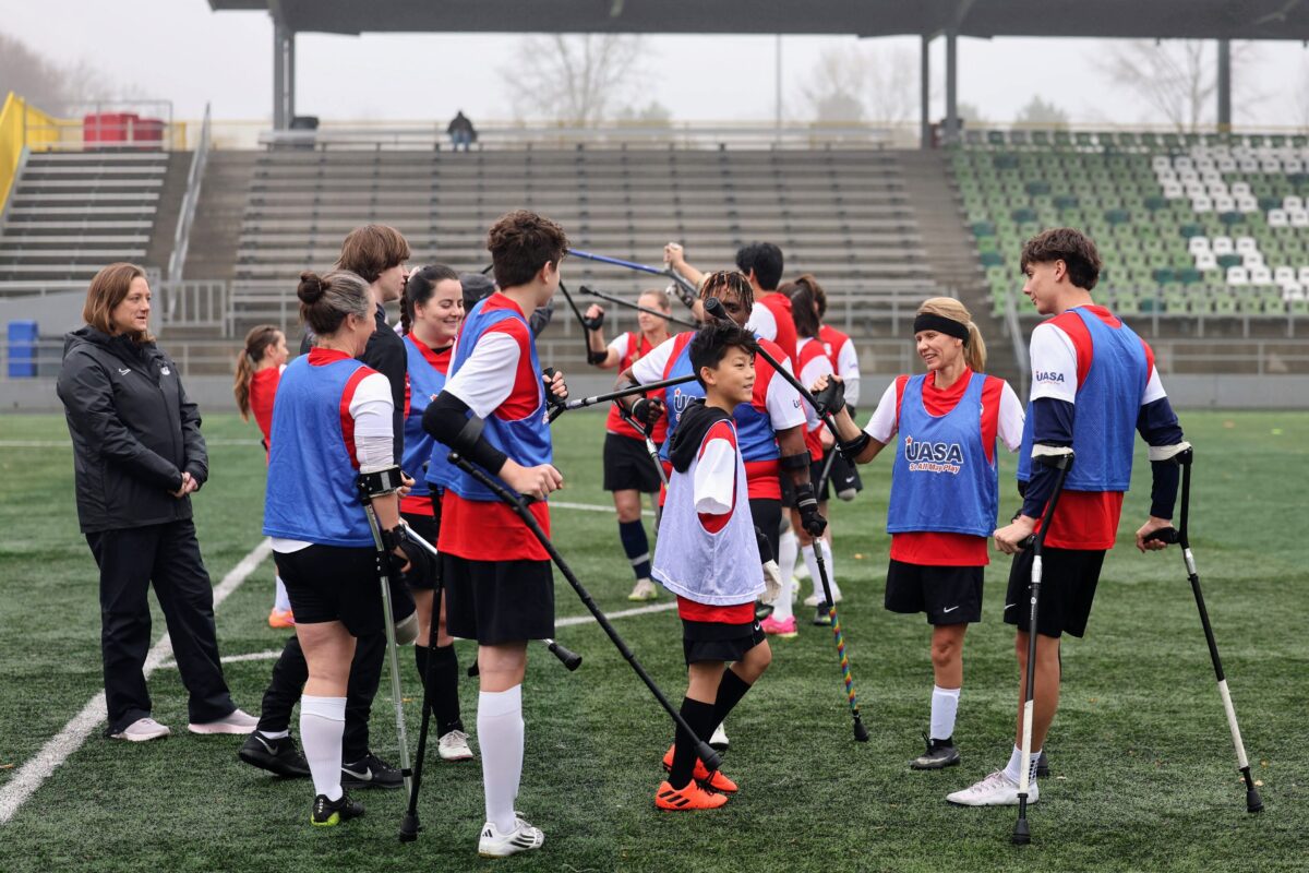 Amputee soccer players of all ages gather to ashake hands after a scrimmage