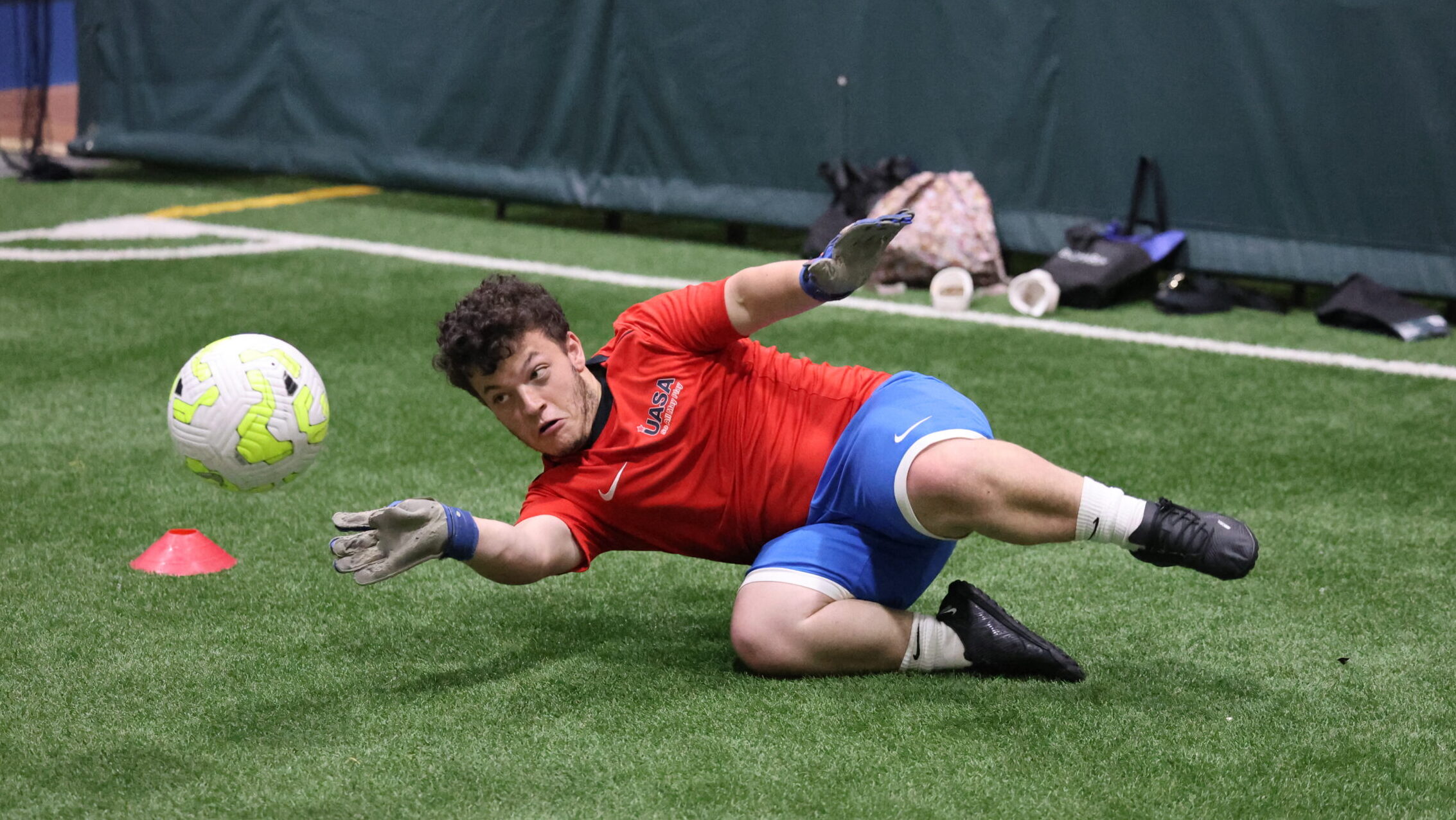 Dwarf soccer goalkeeper Ethan dives to save a shot