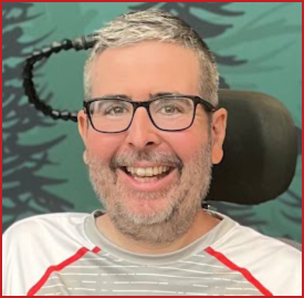 A headshot of Ryan Kenneally, smiling to the camera
