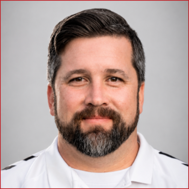 Filip Handl, smiling to the camera, wearing a white polo shirt