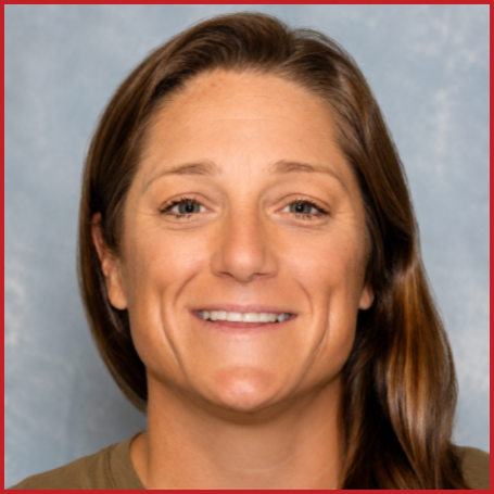 Shannon Hartinger smiles to the camera, wearing a brown shirt
