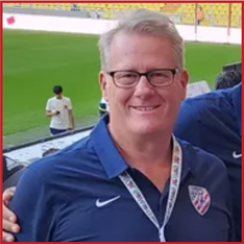 Dan Broome smiles to the camera, wearing a lanyard and his American Amputee Soccer Association uniform